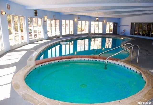 community pool featuring an indoor in ground hot tub