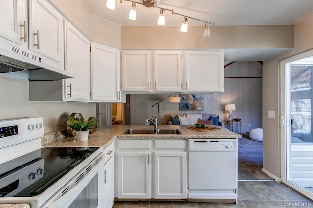 kitchen featuring sink, white appliances, rail lighting, white cabinets, and kitchen peninsula