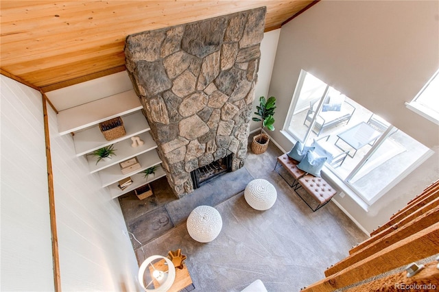 living room featuring a stone fireplace