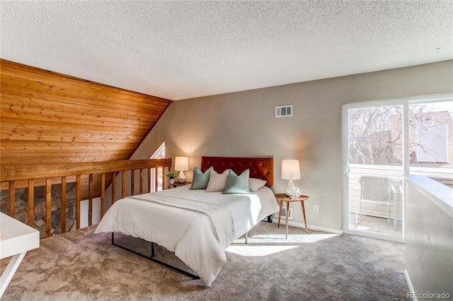 carpeted bedroom with lofted ceiling and a textured ceiling