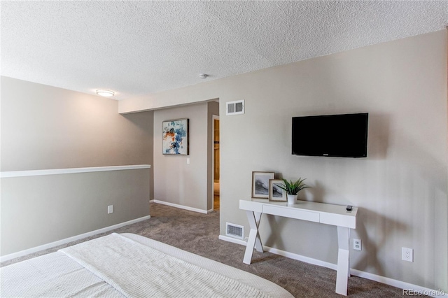 bedroom featuring carpet and a textured ceiling