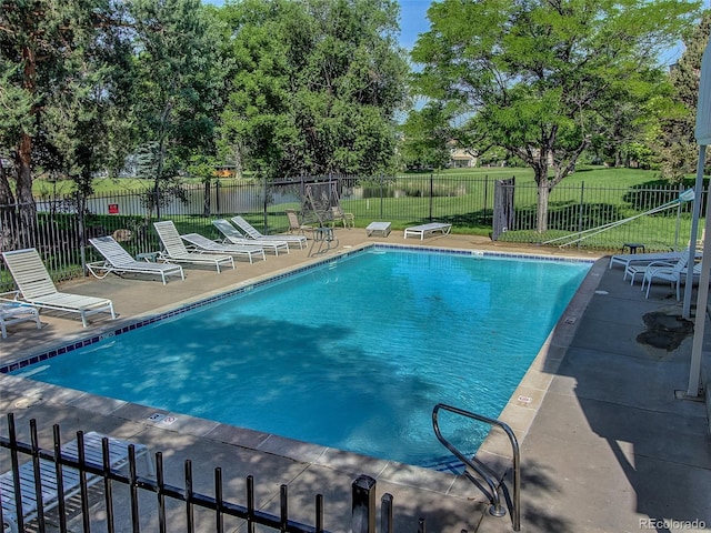 view of pool featuring a patio area and a lawn