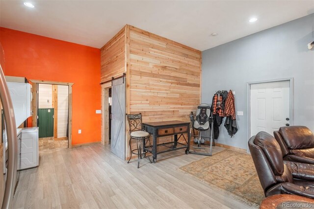 37677 Sable Ridge Rd, Elizabeth, CO 80107 - office featuring a high ceiling, a barn door, wood finished floors, baseboards, and recessed lighting