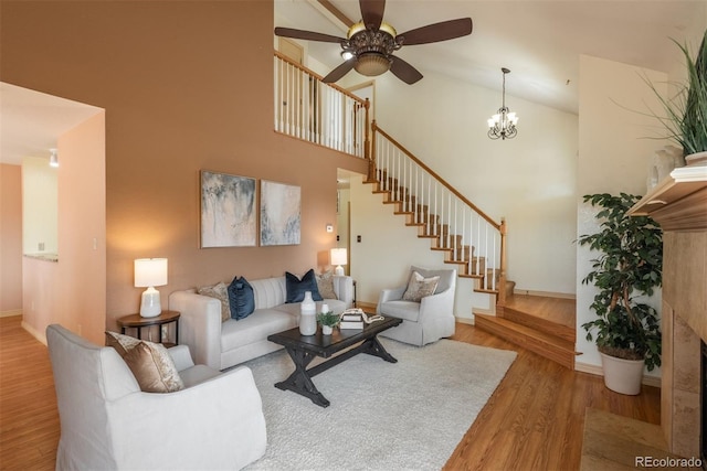 37677 Sable Ridge Rd, Elizabeth, CO 80107 - living room with wood finished floors, a ceiling fan, high vaulted ceiling, stairs, and baseboards