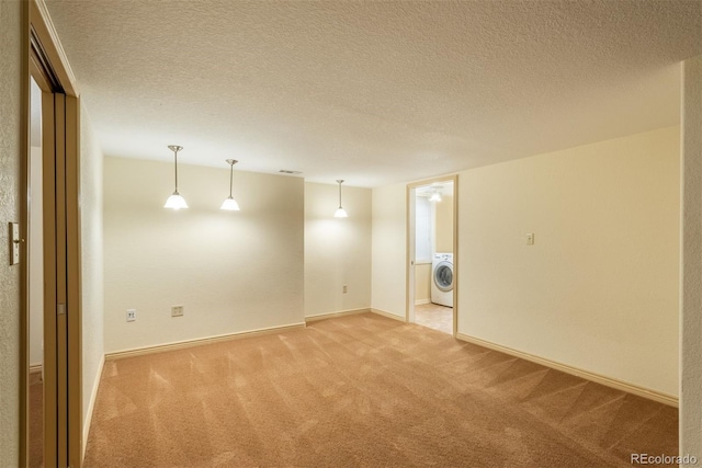 37677 Sable Ridge Rd, Elizabeth, CO 80107 - spare room with washer / clothes dryer, light carpet, baseboards, and a textured ceiling