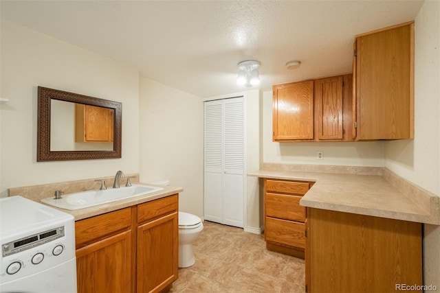 37677 Sable Ridge Rd, Elizabeth, CO 80107 - bathroom featuring washer / dryer, vanity, and toilet