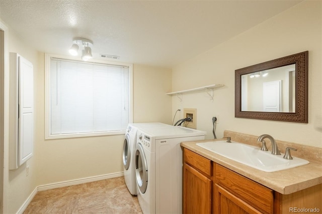 37677 Sable Ridge Rd, Elizabeth, CO 80107 - laundry area with washing machine and dryer, baseboards, and a textured ceiling