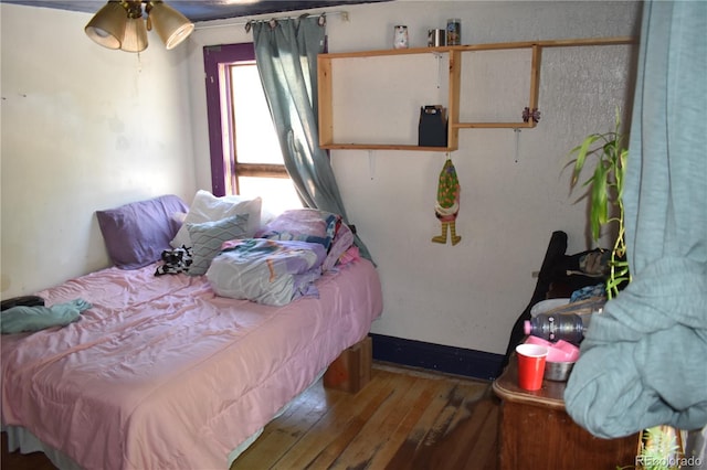 bedroom with wood-type flooring