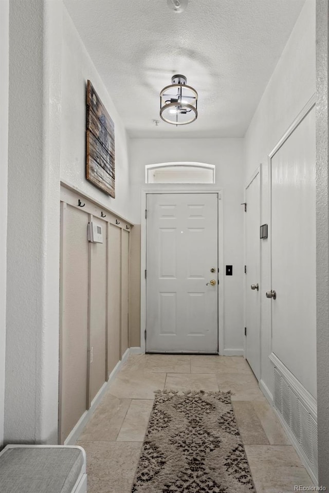 entryway featuring a textured ceiling