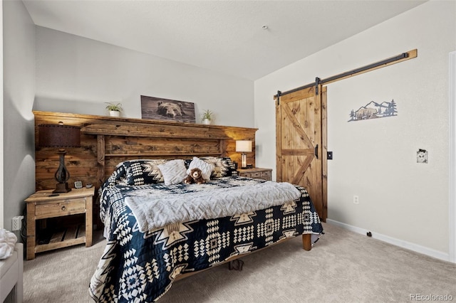 bedroom with light carpet and a barn door