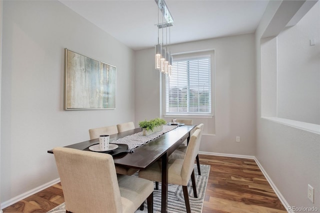 dining area with a chandelier and wood-type flooring