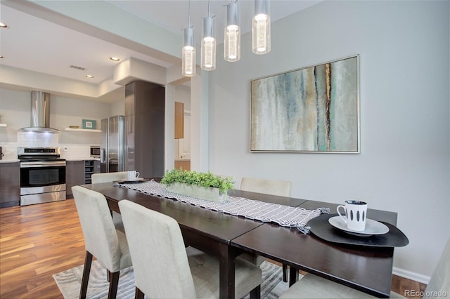 dining space with light wood-type flooring