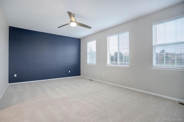 empty room with light colored carpet and ceiling fan