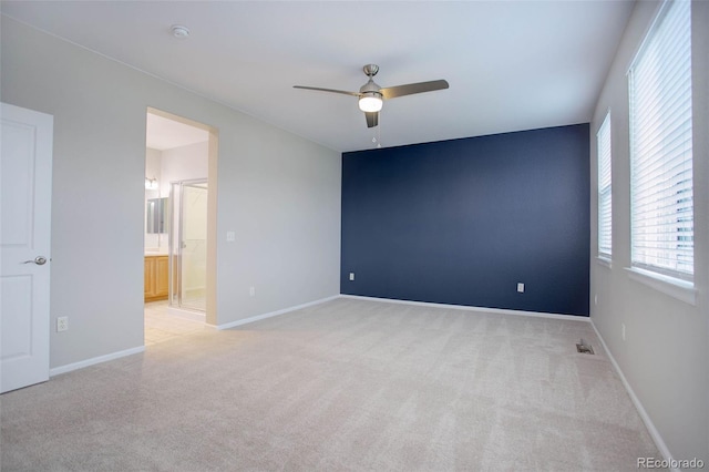 carpeted spare room with ceiling fan