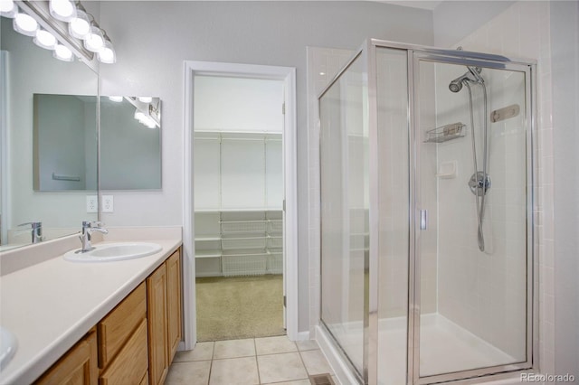 bathroom featuring tile patterned floors, vanity, and walk in shower