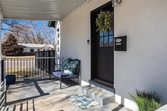 entrance to property featuring stucco siding