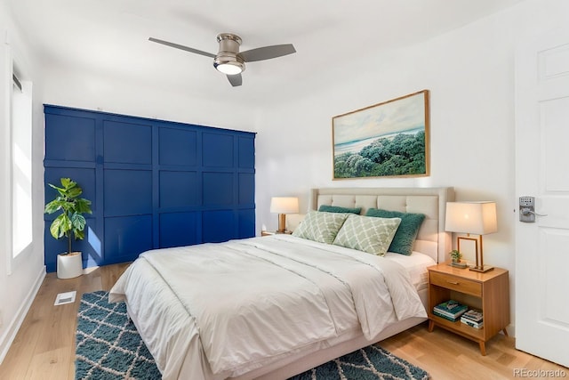 bedroom featuring visible vents, ceiling fan, and light wood finished floors