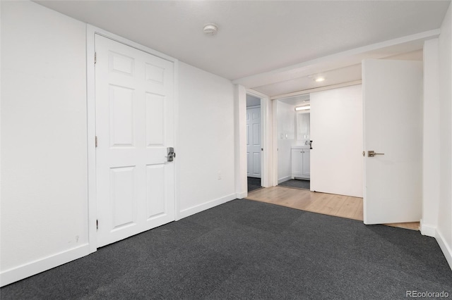 carpeted spare room with baseboards