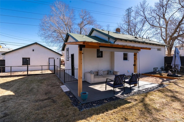 rear view of property featuring a patio area, an outdoor structure, fence, and stucco siding