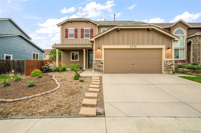 6349 Shooting Iron Way, Colorado Springs, CO 80923 - craftsman-style house featuring board and batten siding, a garage, stone siding, driveway, and roof with shingles