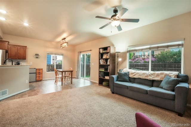 6349 Shooting Iron Way, Colorado Springs, CO 80923 - living area featuring ceiling fan, light colored carpet, and light tile patterned floors