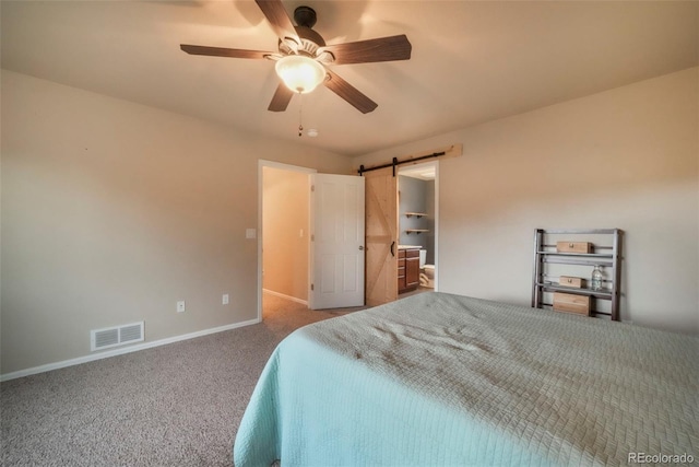 6349 Shooting Iron Way, Colorado Springs, CO 80923 - carpeted bedroom with a barn door and ceiling fan