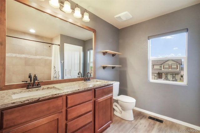 6349 Shooting Iron Way, Colorado Springs, CO 80923 - full bathroom with wood finished floors, double vanity, and tiled shower
