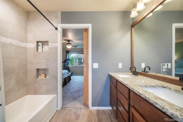 6349 Shooting Iron Way, Colorado Springs, CO 80923 - ensuite bathroom with double vanity, wood finished floors, a ceiling fan, and  shower combination