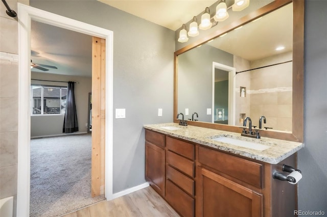 6349 Shooting Iron Way, Colorado Springs, CO 80923 - bathroom featuring double vanity, a ceiling fan, and wood finished floors