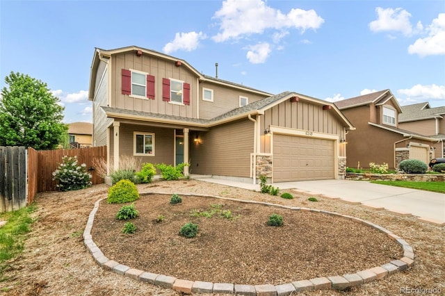 6349 Shooting Iron Way, Colorado Springs, CO 80923 - view of front of house with board and batten siding, an attached garage, driveway, stone siding, and covered porch