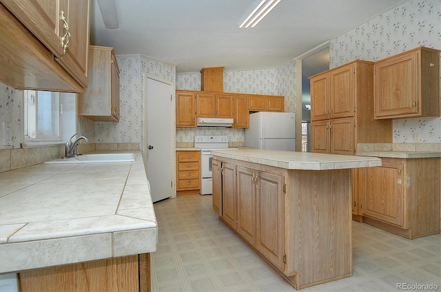 kitchen with white appliances, extractor fan, sink, tile countertops, and a kitchen island