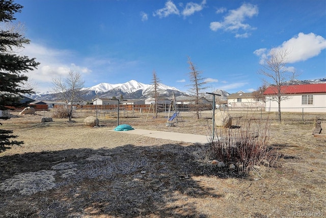 view of yard with a mountain view and a playground