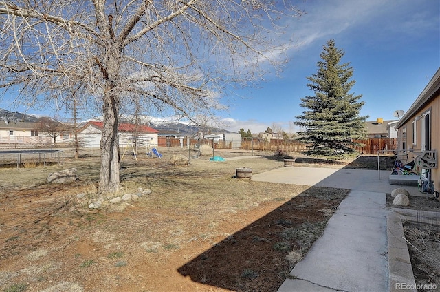 view of yard featuring a patio and a trampoline