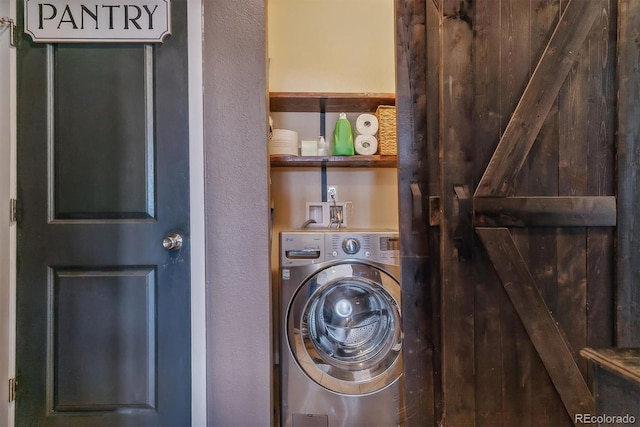 washroom featuring washer / clothes dryer and a barn door