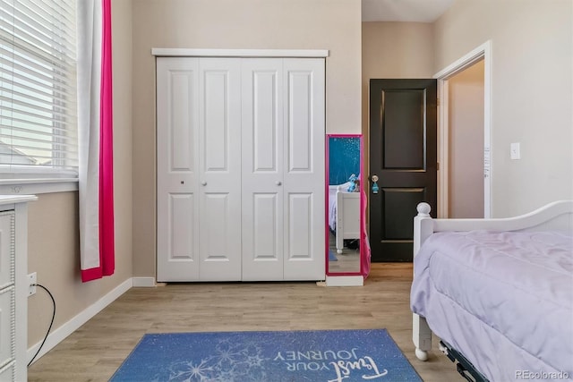 bedroom with a closet and hardwood / wood-style flooring