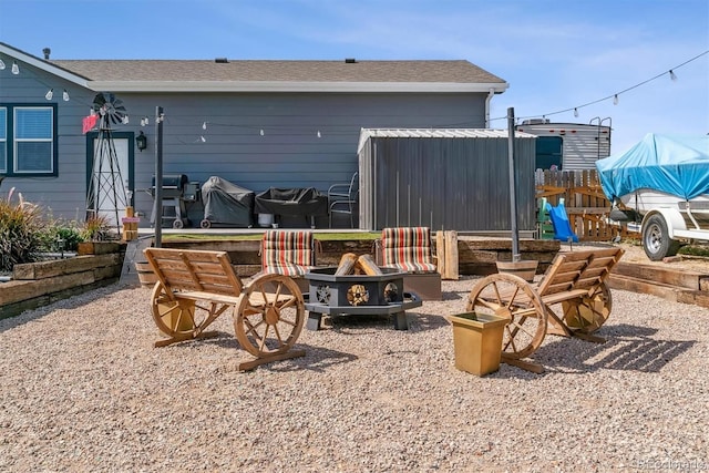 rear view of house with an outdoor fire pit