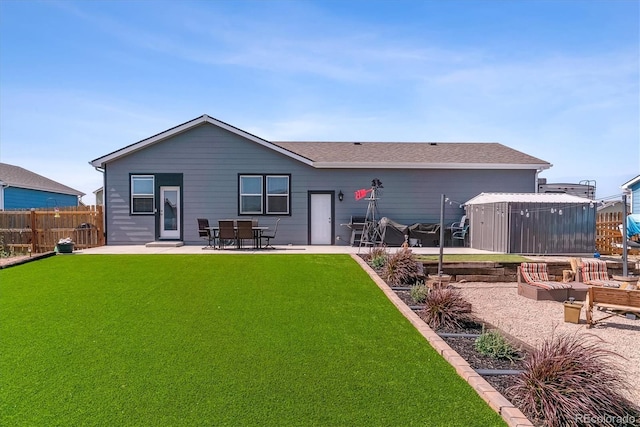 rear view of house featuring a yard and a patio