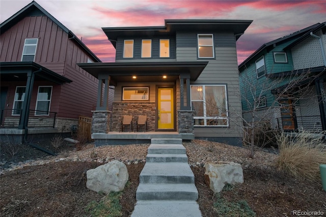 6052 N Malta St, Aurora, CO 80019 - view of front of house featuring covered porch and stone siding