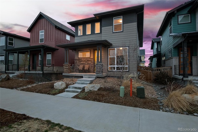 6052 N Malta St, Aurora, CO 80019 - view of front of house with covered porch and stone siding