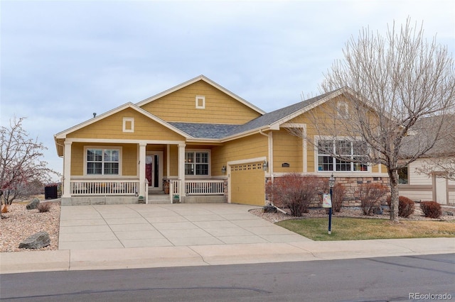 15004 Verbena St, Thornton, CO 80602 - view of front of house featuring driveway, stone siding, a porch, roof with shingles, and a garage