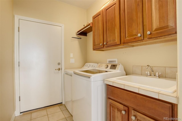 15004 Verbena St, Thornton, CO 80602 - laundry room featuring cabinet space, light tile patterned floors, washing machine and dryer, and a sink
