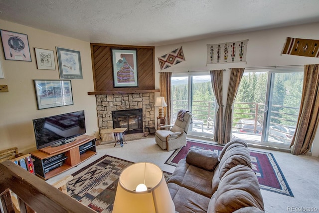 9800 Ryan Gulch Rd Unit A-101, Silverthorne, CO 80498 - living room with a stone fireplace, carpet flooring, and a textured ceiling