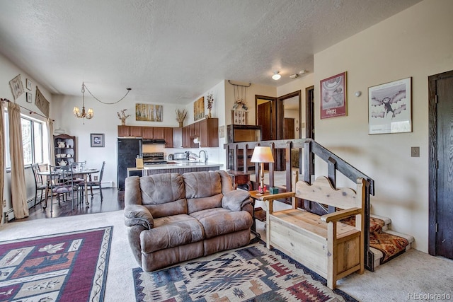 9800 Ryan Gulch Rd Unit A-101, Silverthorne, CO 80498 - living room with a chandelier, a textured ceiling, and light carpet