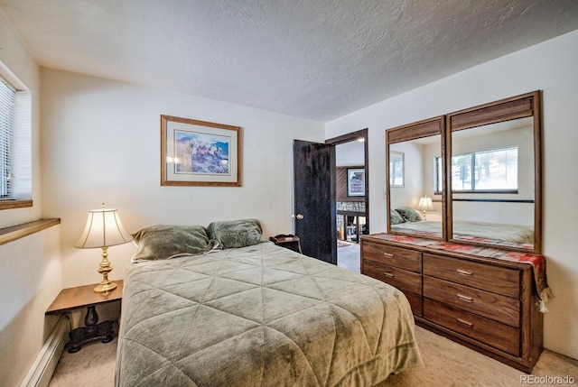 9800 Ryan Gulch Rd Unit A-101, Silverthorne, CO 80498 - bedroom featuring light colored carpet, a baseboard heating unit, and a textured ceiling
