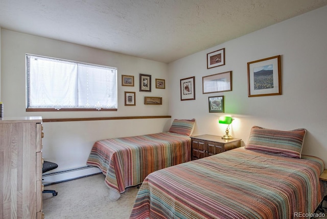 9800 Ryan Gulch Rd Unit A-101, Silverthorne, CO 80498 - carpeted bedroom with a baseboard heating unit and a textured ceiling