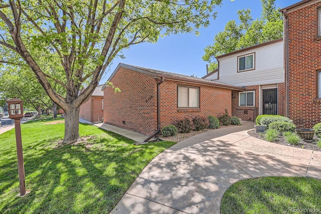 6330 E Wesley Ave, Denver, CO 80222 - view of front of property with brick siding, a front lawn, and a patio
