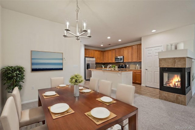 9907 Martin Luther King Blvd Unit 103, Denver, CO 80238 - dining area with light colored carpet, a chandelier, recessed lighting, a tile fireplace, and baseboards