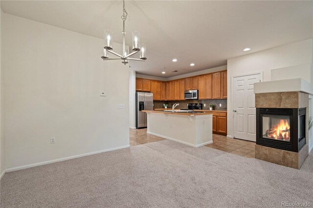 9907 Martin Luther King Blvd Unit 103, Denver, CO 80238 - kitchen with appliances with stainless steel finishes, a sink, a chandelier, recessed lighting, and light colored carpet