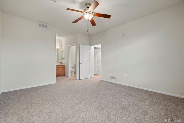 9907 Martin Luther King Blvd Unit 103, Denver, CO 80238 - unfurnished bedroom with light colored carpet, baseboards, and ensuite bath
