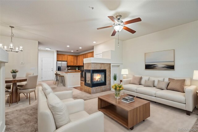 9907 Martin Luther King Blvd Unit 103, Denver, CO 80238 - living room with a chandelier, a ceiling fan, a tile fireplace, light carpet, and recessed lighting